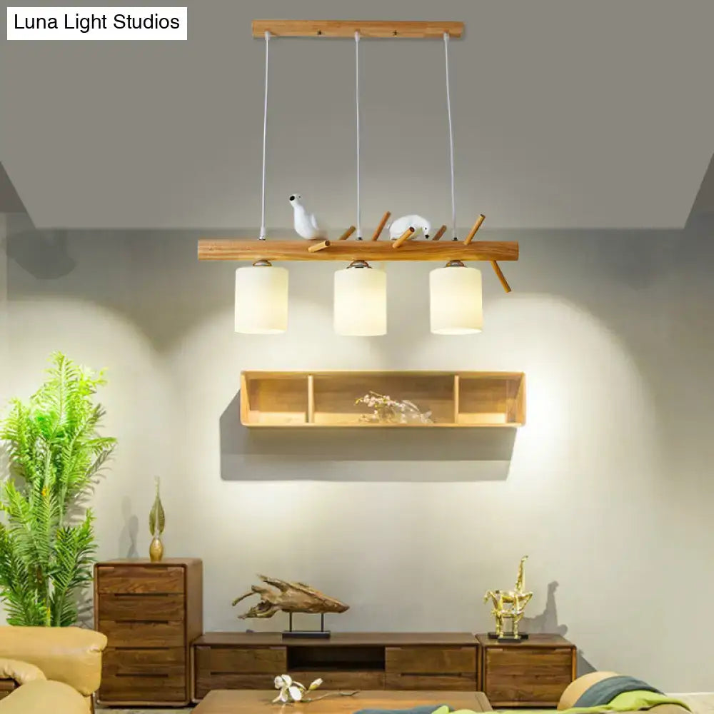 DecorBites modern island pendant light with frosted glass shades and wooden bar with decorative bird figurines