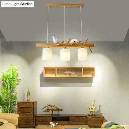 DecorBites modern island pendant light with frosted glass shades and wooden bar with decorative bird figurines