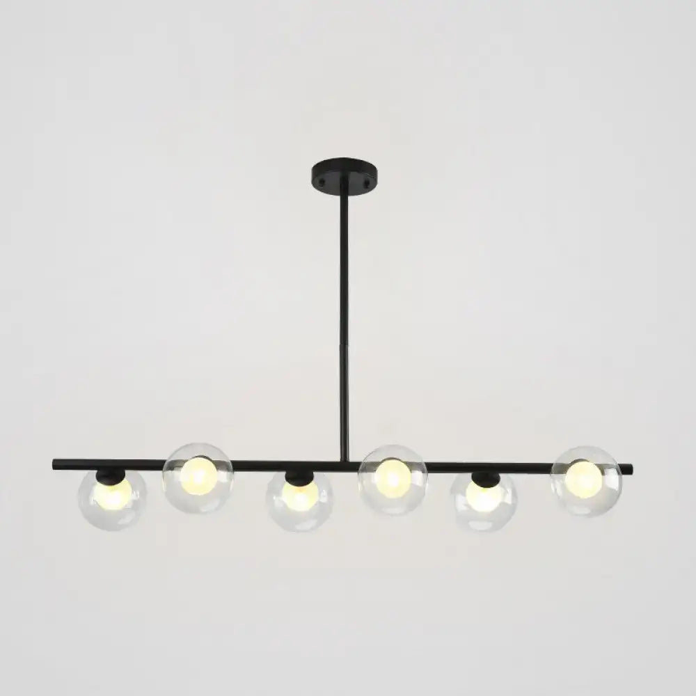Modern black island pendant with clear glass globes featuring five black gold globe bulbs for dining room lighting