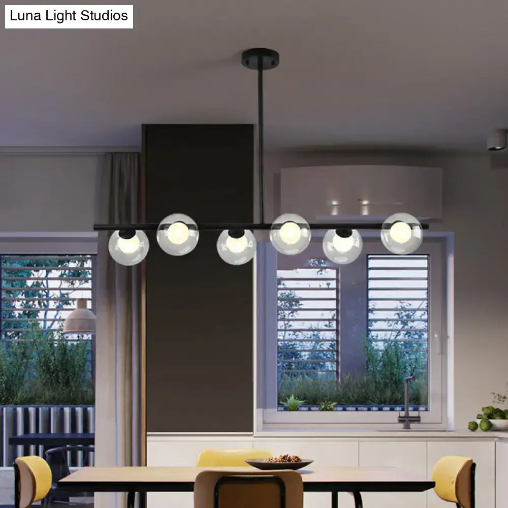 Modern black island pendant chandelier with five clear glass globes featuring black gold metal accents for dining room use