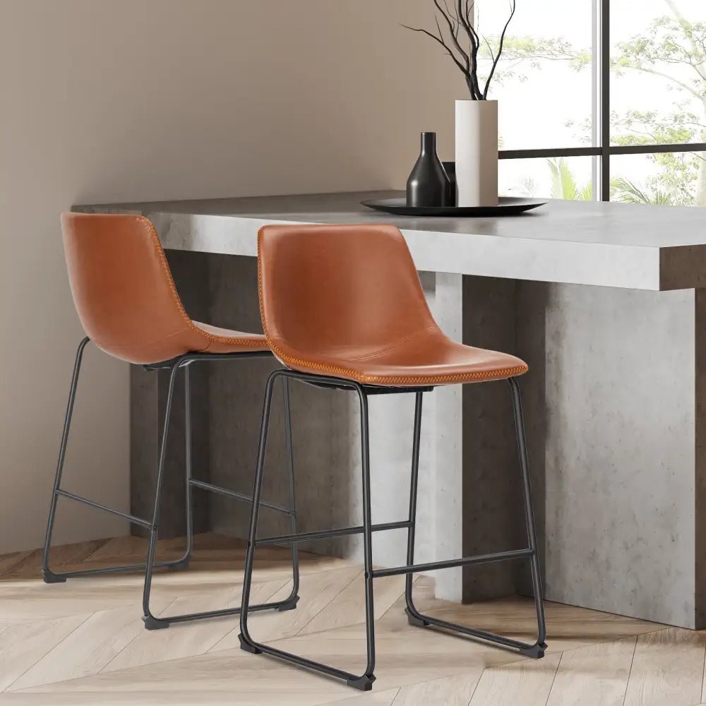 Modern black leather bar stools with gold stitching for kitchen island - Decorbites