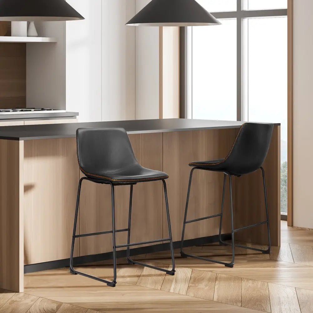 Modern black leather bar stools with gold stitching for kitchen island - Decorbites