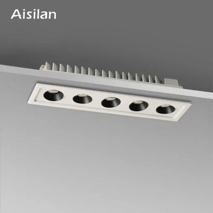 Modern black led grille downlight with five black circular led spots in a white rectangular recessed ceiling fixture
