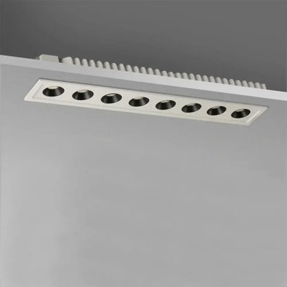 Modern black led grille downlight with six black circular led bulbs in a white rectangular recessed ceiling fixture
