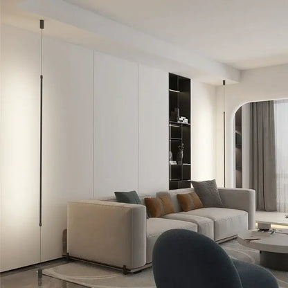 Beige upholstered sectional sofa with gray and brown pillows under decorbites black modern led pendant light for dining room