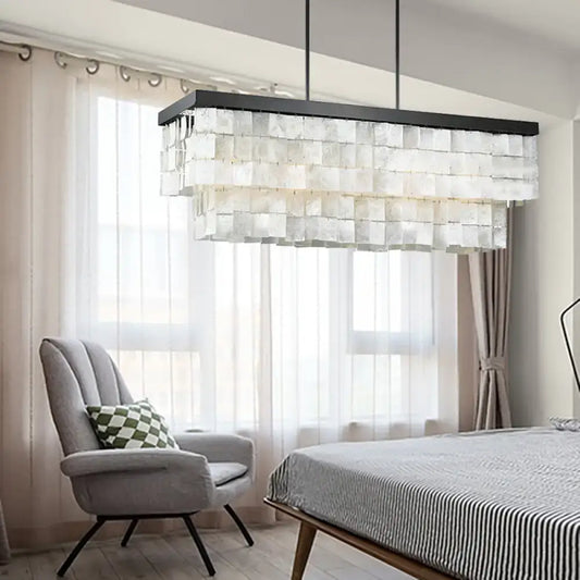 Modern rectangular decorbites™ island light fixture with layered translucent glass panels and black metal frame for living room