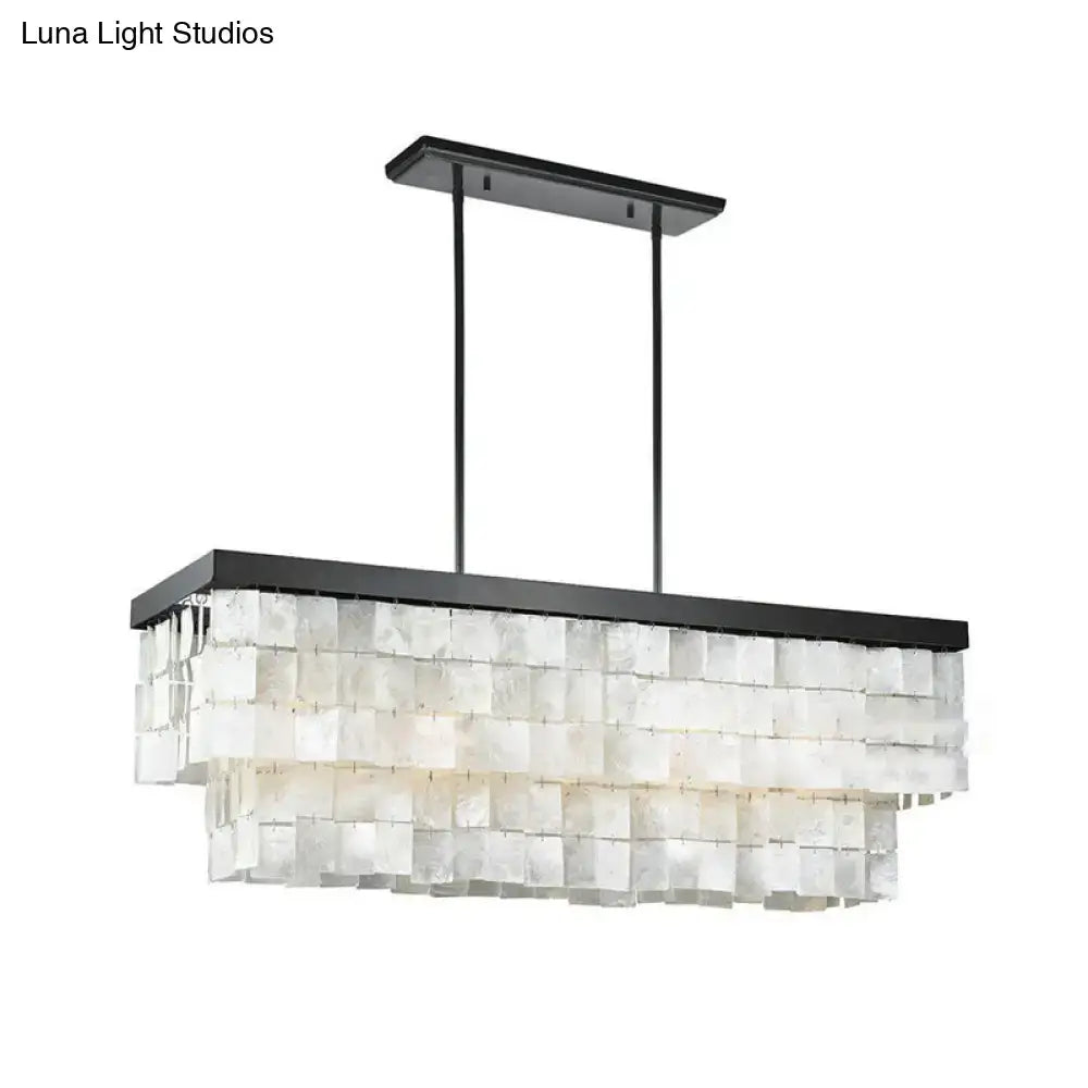 Black metal rectangular island light fixture with layered translucent white shell panels for living room decor