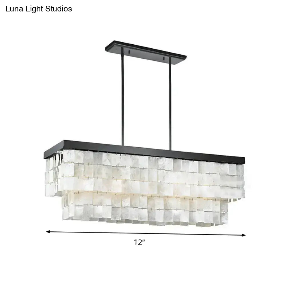 Black metal rectangular island light fixture with layered translucent white shell panels for modern living rooms