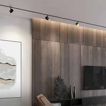 Modern black led track spotlight with three adjustable spotlights mounted on a kitchen ceiling rail