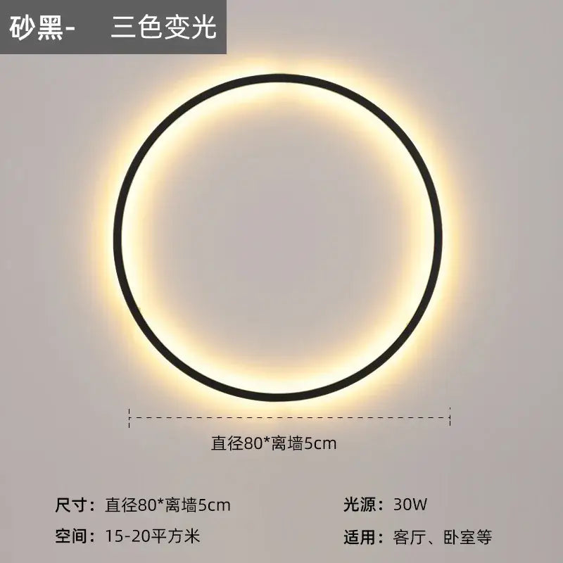 A sleek black modern led wall circle light with a warm glowing ring for living room wall circle lights
