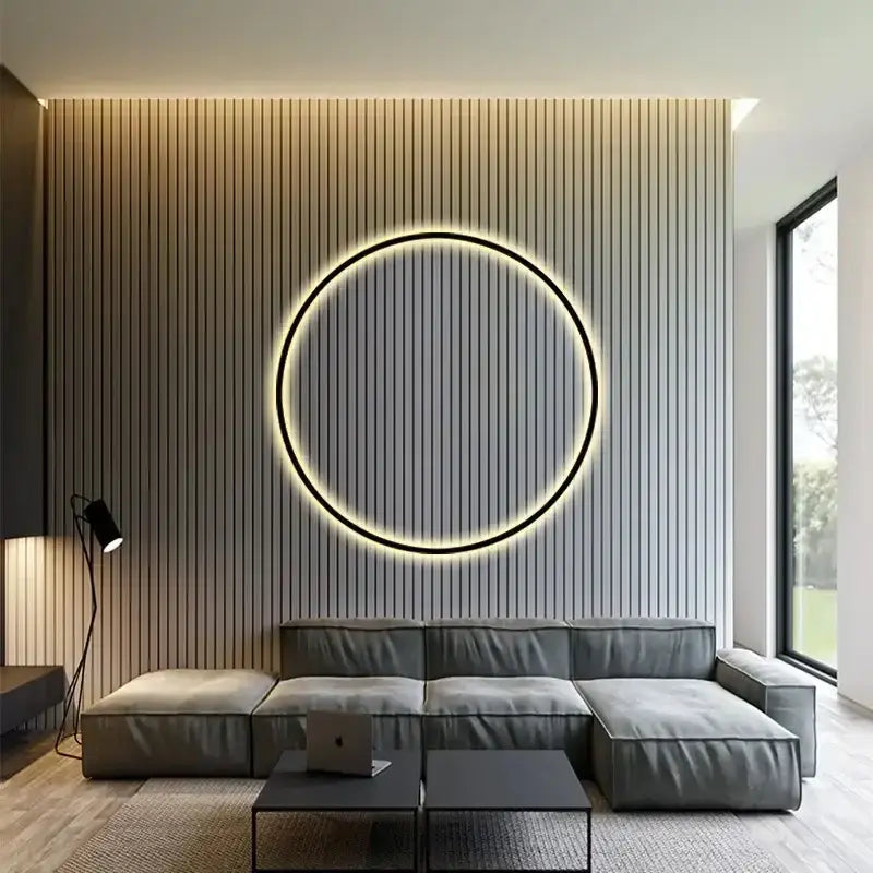 Modern black led wall circle light with warm glow and black frame mounted on a vertically slatted gray wall