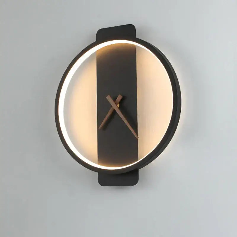 Modern black led wall clock with glowing circular light ring and minimalist wooden hands for living room use
