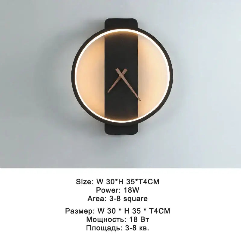Modern black led wall clock lamp with a circular design, black stripe, bronze hands, and warm ambient lighting edges
