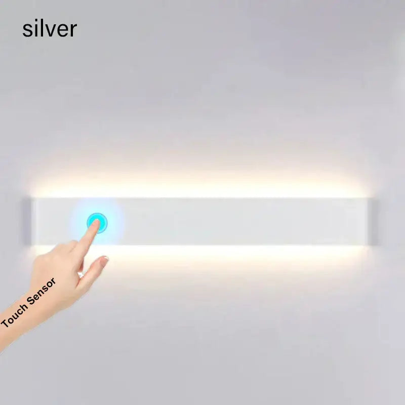 Silver rectangular decorbites led wall lamp with touch sensor illuminated by soft white glow for modern bedroom decor