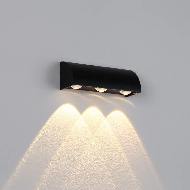 Modern black led wall lamp with three warm white lights mounted on a curved wall lighting fixture for bedroom use