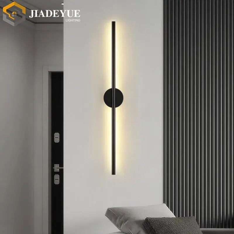 Modern black led wall lamp set featuring minimalist vertical bar and circular base emitting warm ambient light