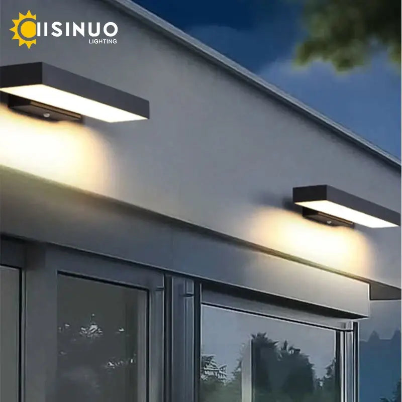 Modern black led wall light with dusk dawn motion sensor emitting warm white light for outdoor use