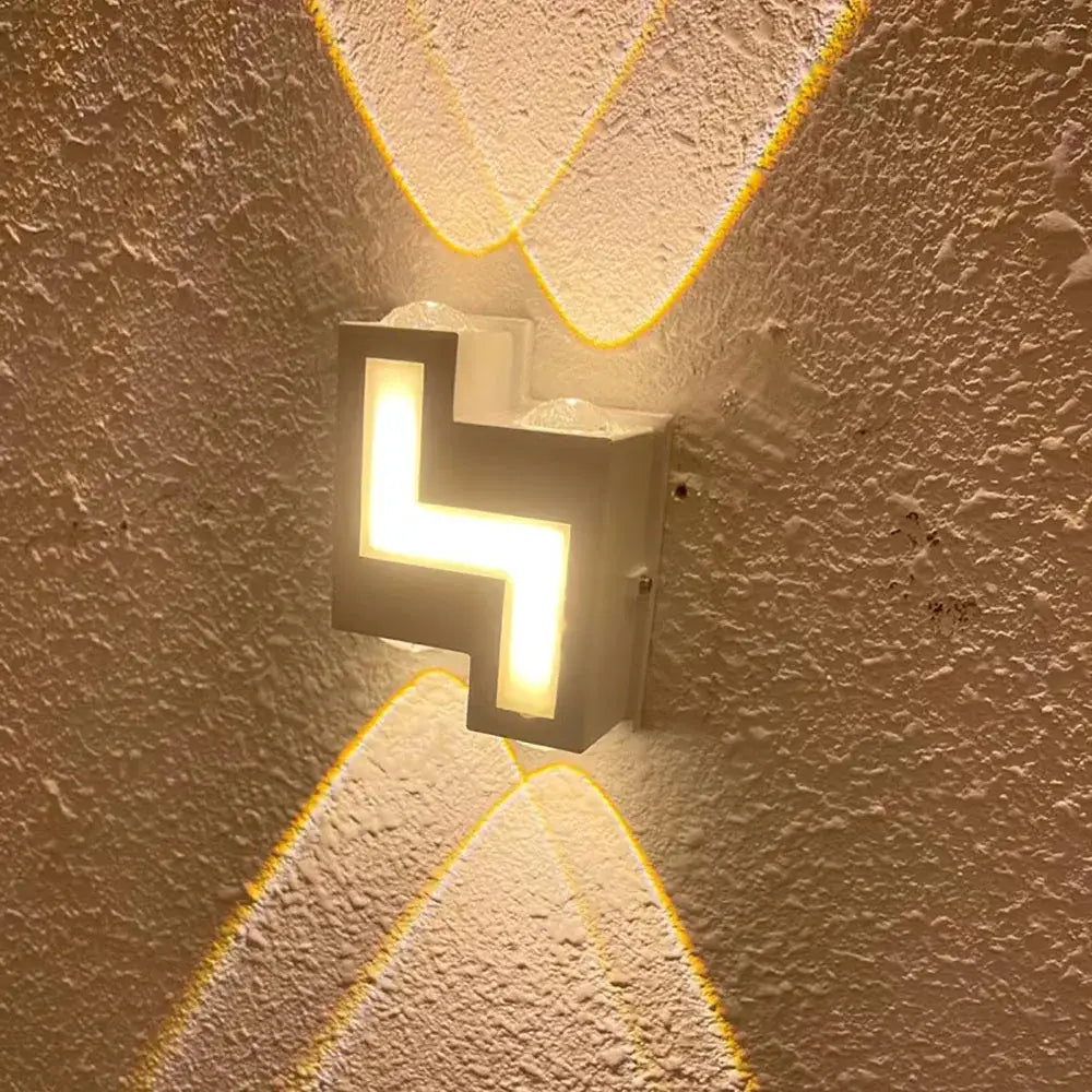 Modern black geometric wall lamp emitting warm yellow light with decorbites ip65 led waterproof design
