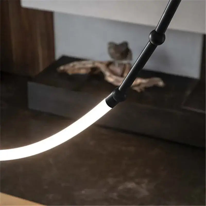 Black line chandelier led light strands featuring a modern articulated led light stick with glowing white strip decorbites leda black