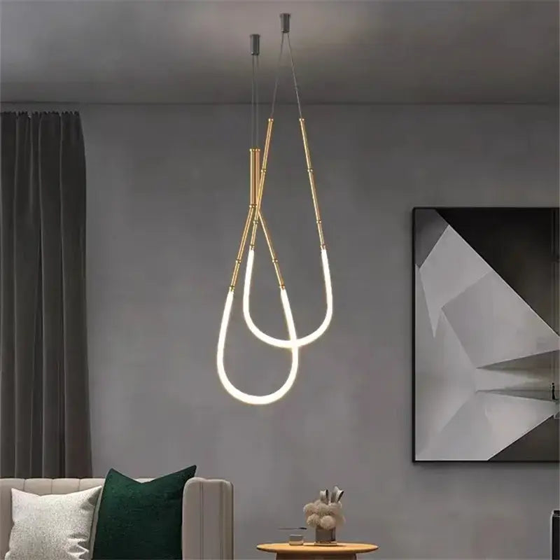 Modern gold-toned pendant light with sleek curved led tubes in decorbites leda black line chandelier for dining room