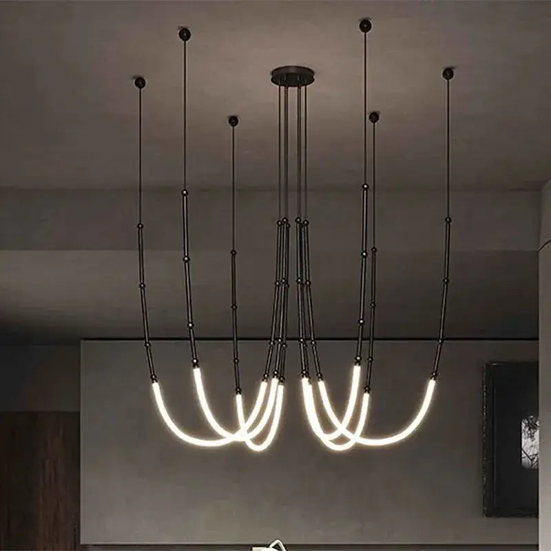 Modern black line chandelier with curved glowing white led light strands for dining room decorbites leda black design