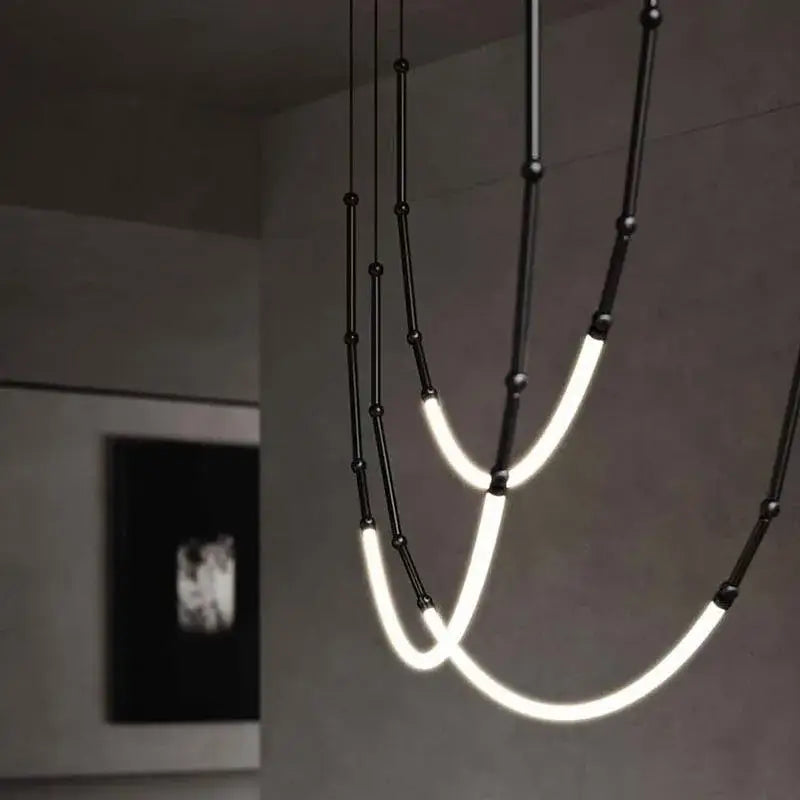 Modern black line chandelier by decorbites leda black features curved glowing led tubes and spherical accents for dining room decor
