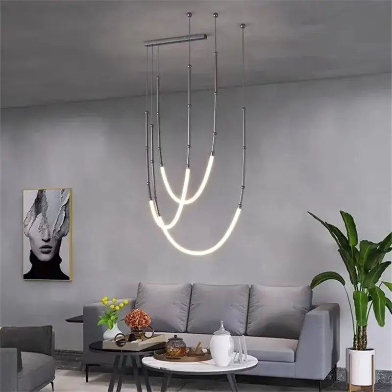 Modern black line chandelier with sleek curved led tubes suspended by thin metallic rods for dining room decorbites leda black