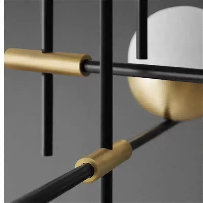 Modern black linear chandelier with glass ball shades featuring geometric black metal rods and gold-toned accents for kitchen decorbites glass ball