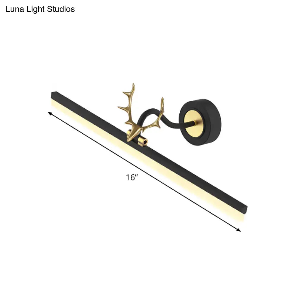 Modern black linear deer vanity light with black and gold antler-themed design and warm white led illumination