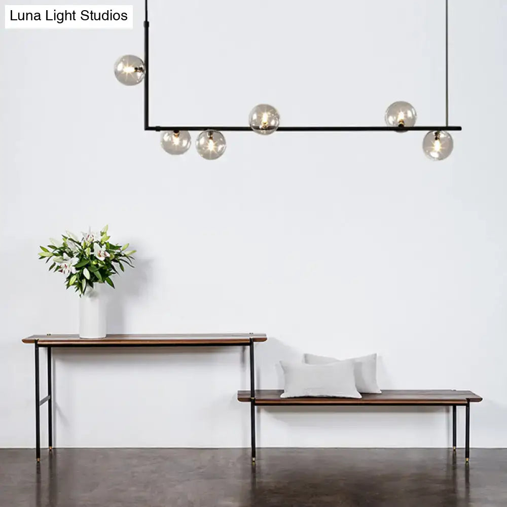 Modern black metal chandelier with five spherical glass shade globes for dining room linear island pendant lighting