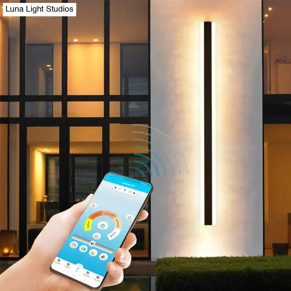 Modern black and white linear aluminum wall sconce by DecorBites™ emitting warm light for outdoor use with IP65 rating