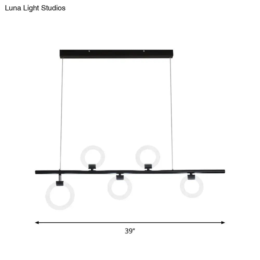 Black modern metallic chandelier light fixture with three circular rings suspended from a horizontal linear bar