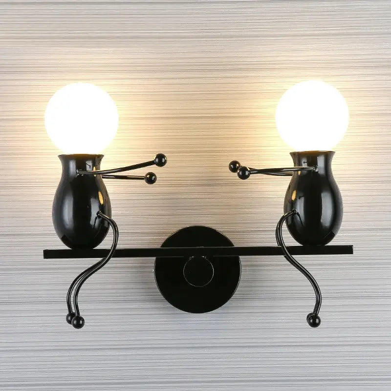 Modern black metal wall light featuring two whimsical vase-shaped figures holding spherical bulbs as man led wall light