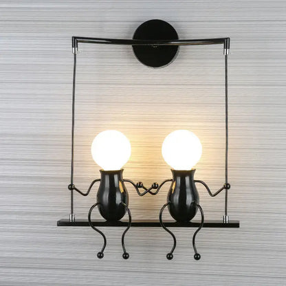 Modern black metal wall light with two whimsical man led wall figurines and glowing spherical led bulbs for bedroom