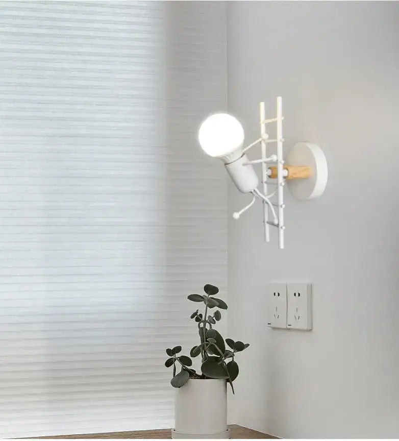 Modern black little man led wall light with white ladder design, wooden accent, and exposed bulb for bedroom use