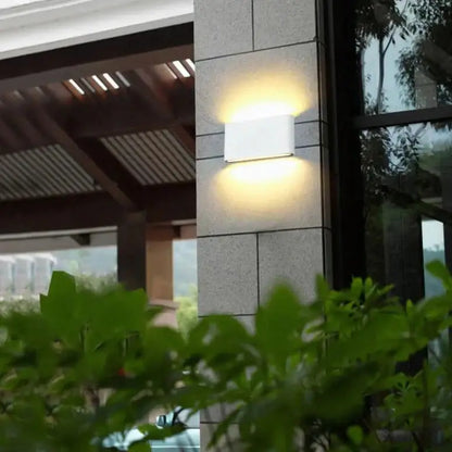 White rectangular luna outdoor wall light fixture emitting warm glow for modern black patio lighting