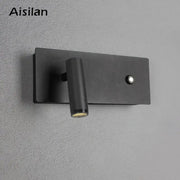Modern black matte led wall sconce with cylindrical adjustable head and button on rectangular base for bedroom reading light