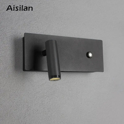 Modern black matte led wall sconce with cylindrical adjustable head and button on rectangular base for bedroom reading light