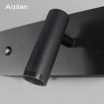 Modern black matte led wall sconce with cylindrical design and sleek finish ideal for bedroom reading light