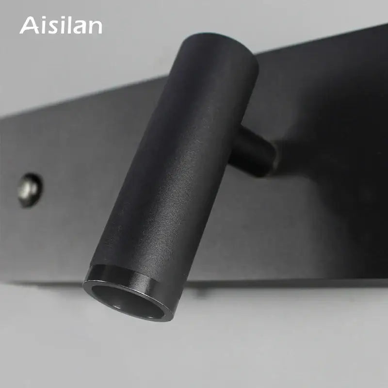 Modern black matte led wall sconce with cylindrical design and sleek finish ideal for bedroom reading light