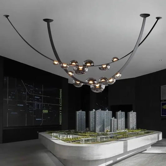 Modern black metal chandelier pendant light with curved arms and globe glass lights for decorbites designer leather loft