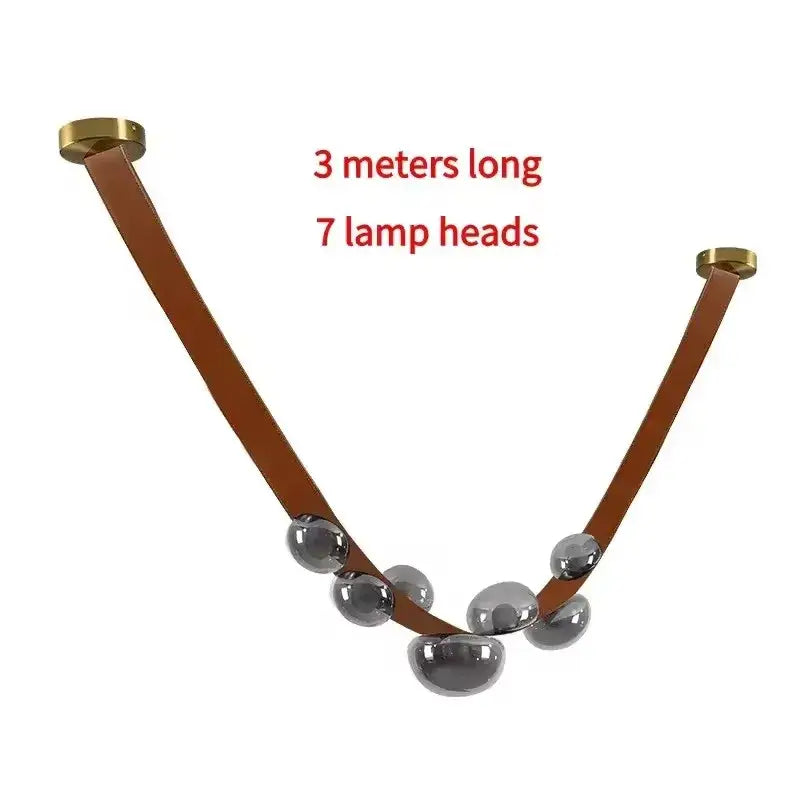 Modern black metal pendant light with v-shaped design, brown decorbites designer leather strap, and seven chrome globe lamps