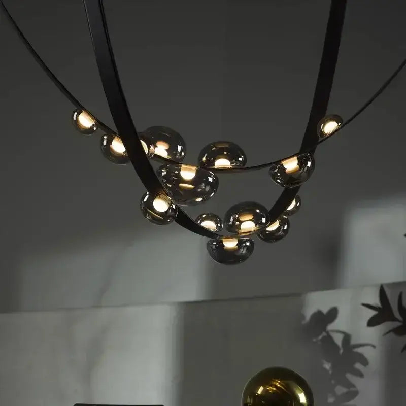 Modern black metal pendant light with spherical glass bulbs and designer leather loft style for living room decorbites