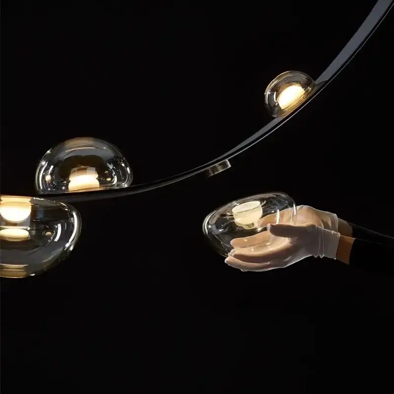 Modern black metal pendant light chandelier with curved arms and clear glass globes for living room decorbites designer leather loft