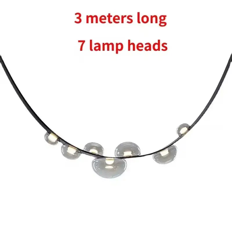 A sleek black metal pendant light with seven translucent dome glass heads for modern decorbites designer leather loft decor