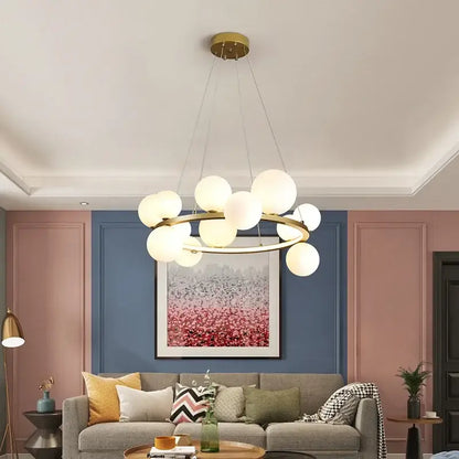 Modern black metal chandelier with gold-toned frosted clear glass led spheres in circular decorbites clear glass design