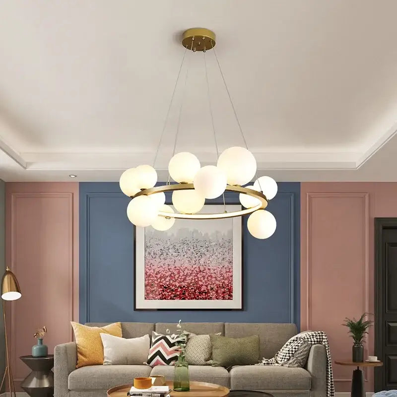 Modern black metal chandelier with gold-toned frosted clear glass led spheres in circular decorbites clear glass design