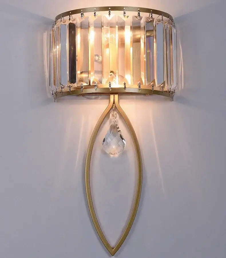 Gold-toned led wall lamp with vertical crystal bars and teardrop pendant in modern black metal for living room