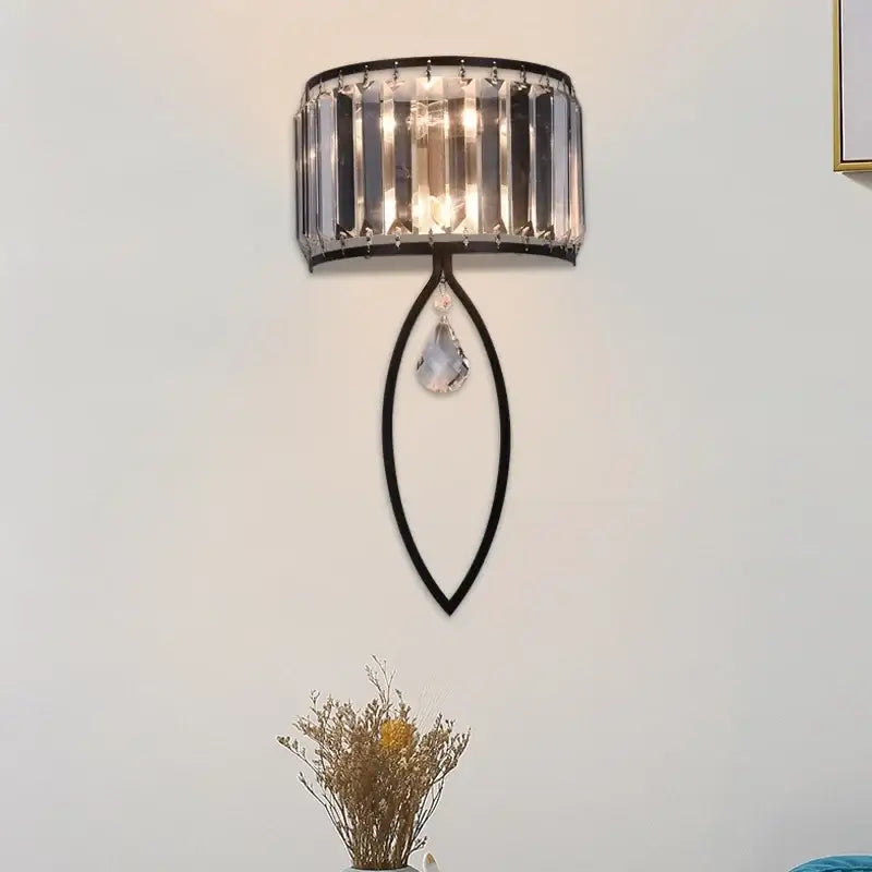 Modern black metal led wall lamp featuring vertical crystal bars and a teardrop crystal pendant for living room