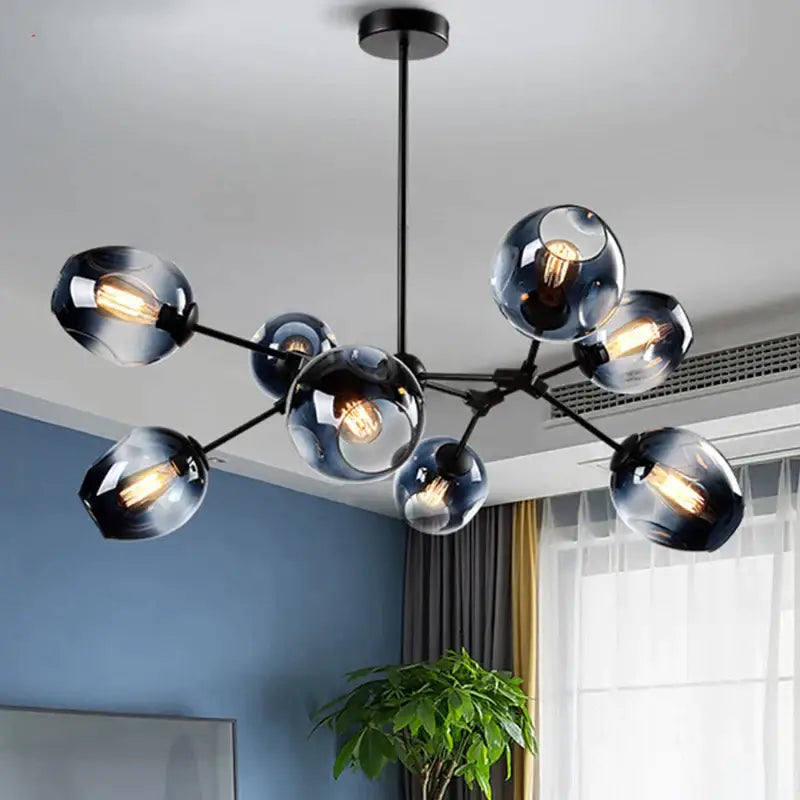 Modern black metal decorbites glass chandelier with frosted glass spheres and warm filament bulbs for dining room